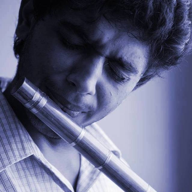Prinkit playing Carnatic flute showcasing musical artistry